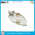 White leaves with bird ceramic ring dish wedding centerpiece